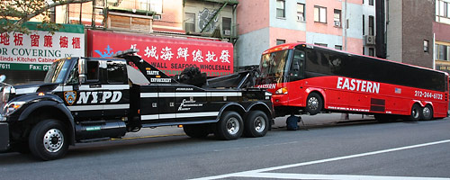 Bus being towed by NYPD Traffic